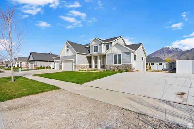 516 W 1000 N, Mapleton, UT 84664 - view of front facade with board and batten siding, concrete driveway, stone siding, and fence