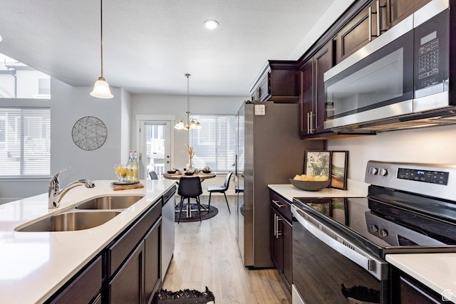 1629 N 3860 W, Lehi, UT 84043 - kitchen with light countertops, appliances with stainless steel finishes, decorative light fixtures, and a sink
