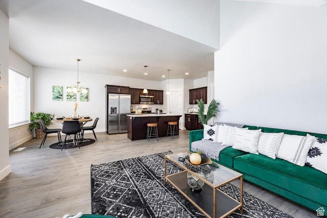 1629 N 3860 W, Lehi, UT 84043 - living area featuring baseboards, light wood-type flooring, and an inviting chandelier
