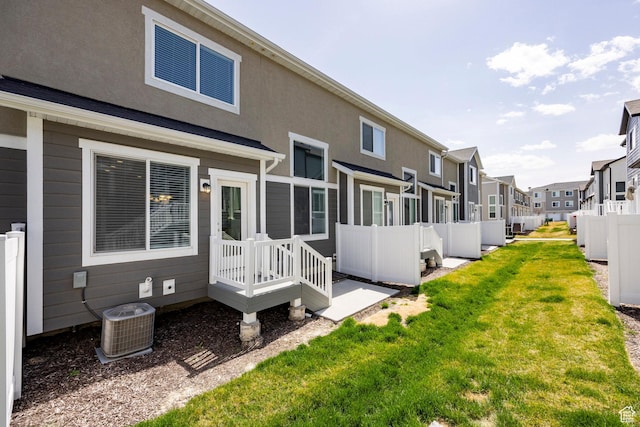 1629 N 3860 W, Lehi, UT 84043 - back of property featuring a residential view, stucco siding, central AC unit, fence, and a lawn