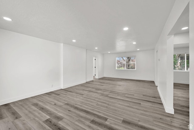 1289 E 31st St S, Ogden, UT 84403 - unfurnished living room featuring wood finished floors, baseboards, and recessed lighting
