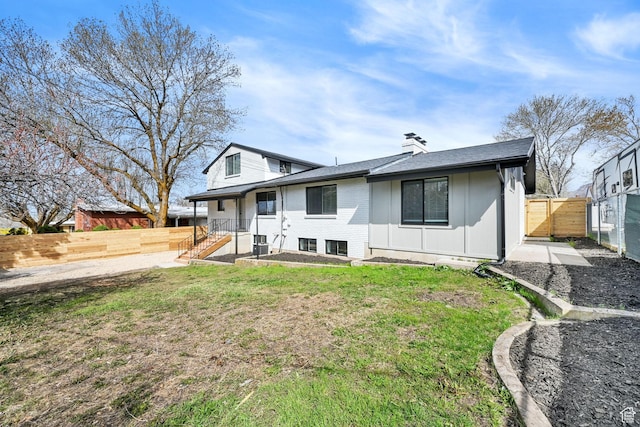 1289 E 31st St S, Ogden, UT 84403 - view of front of property with a front yard, fence, and a chimney