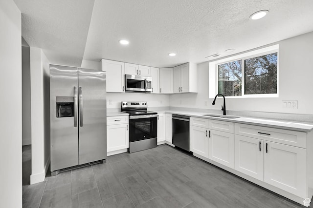 1289 E 31st St S, Ogden, UT 84403 - kitchen with light countertops, appliances with stainless steel finishes, a sink, and white cabinetry