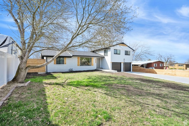 1289 E 31st St S, Ogden, UT 84403 - tri-level home featuring driveway, an attached garage, a front yard, brick siding, and fence