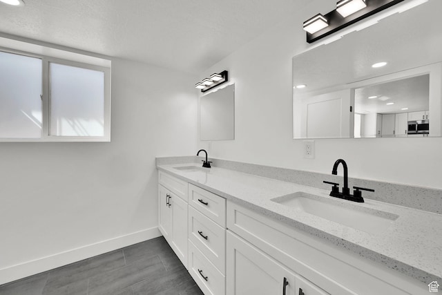 1289 E 31st St S, Ogden, UT 84403 - bathroom with double vanity, a sink, and baseboards