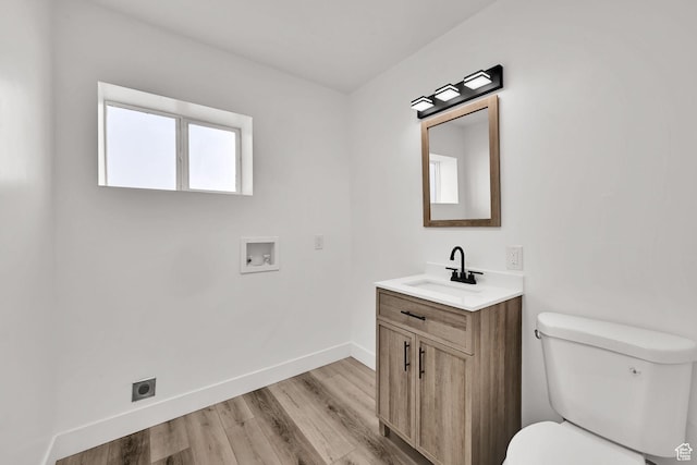 1289 E 31st St S, Ogden, UT 84403 - bathroom with toilet, wood finished floors, vanity, and baseboards