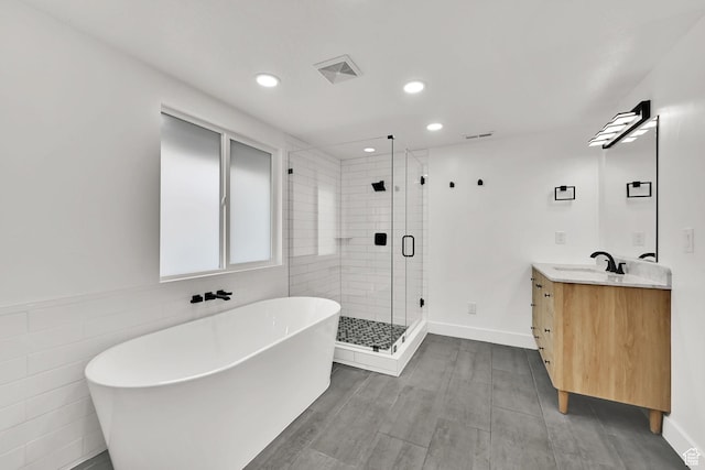 1289 E 31st St S, Ogden, UT 84403 - bathroom with visible vents, a soaking tub, recessed lighting, vanity, and a stall shower