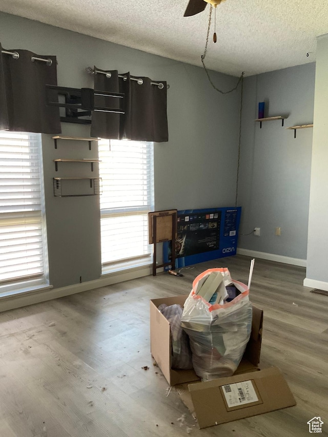 5196 S Gravenstein W, Murray, UT 84123 - living room with a textured ceiling, wood finished floors, baseboards, and a ceiling fan