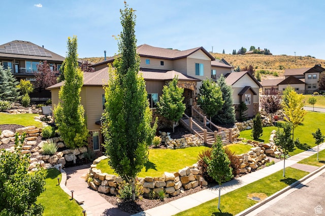 view of front of property with a residential view and a front lawn