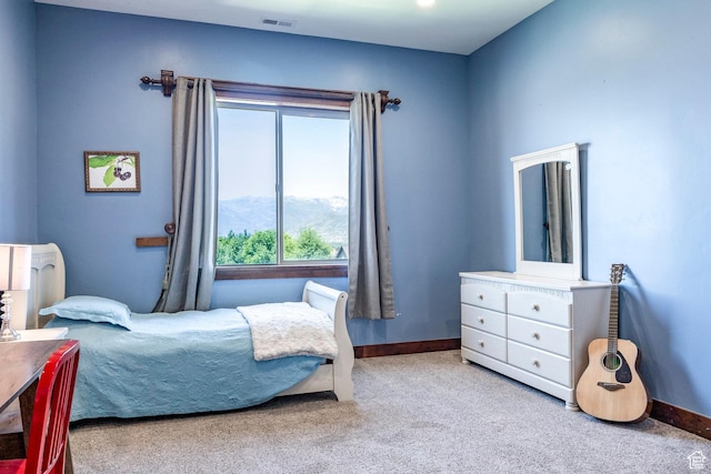 bedroom featuring a mountain view, baseboards, visible vents, and carpet floors