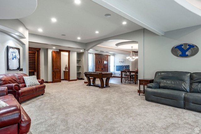 living area with recessed lighting, arched walkways, carpet, and a chandelier