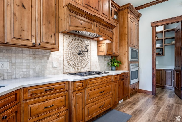 kitchen with brown cabinets, appliances with stainless steel finishes, and light countertops
