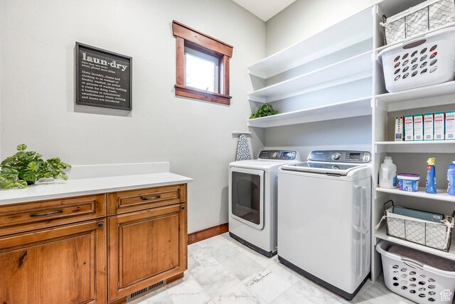washroom featuring marble finish floor and washing machine and clothes dryer