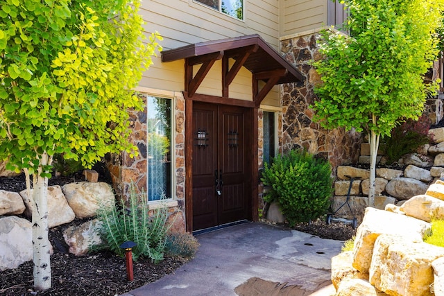 view of exterior entry featuring stone siding