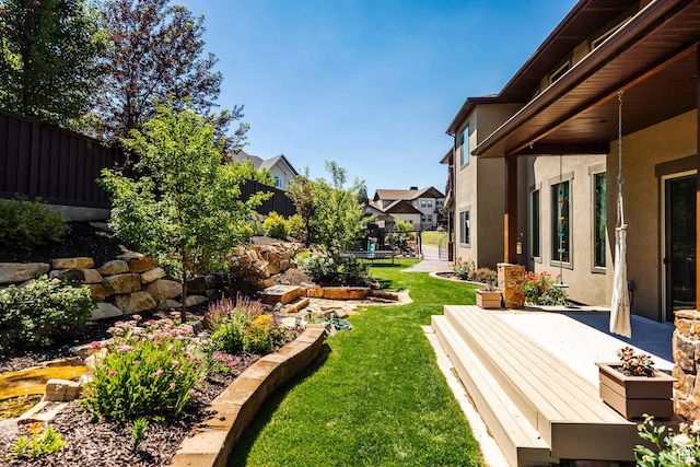 view of yard featuring a fenced backyard and a residential view