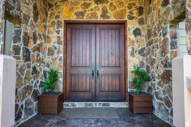 view of exterior entry featuring stone siding