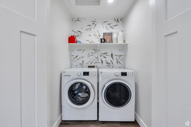 laundry area featuring washer and clothes dryer, wood finished floors, laundry area, and baseboards