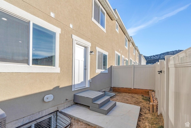 view of patio with a mountain view and a fenced backyard