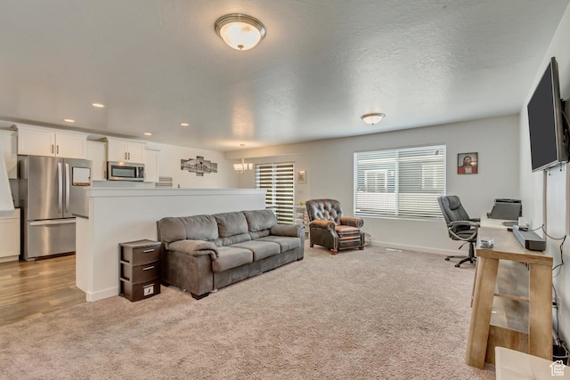 483 S Fox Chase Ln, Saratoga Springs, UT 84045 - living area with baseboards, an inviting chandelier, a textured ceiling, recessed lighting, and light colored carpet