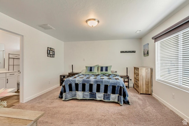 483 S Fox Chase Ln, Saratoga Springs, UT 84045 - bedroom with light colored carpet, baseboards, visible vents, and ensuite bath