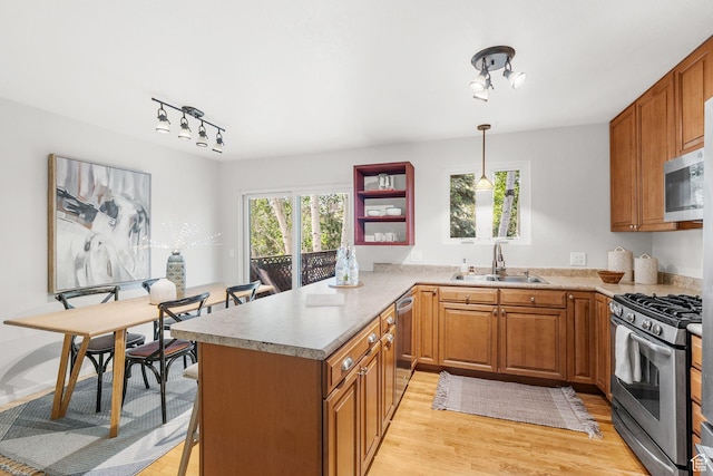 745 Quaking Aspen Ct, Park City, UT 84060 - kitchen with appliances with stainless steel finishes, light wood-style flooring, brown cabinetry, a peninsula, and rail lighting