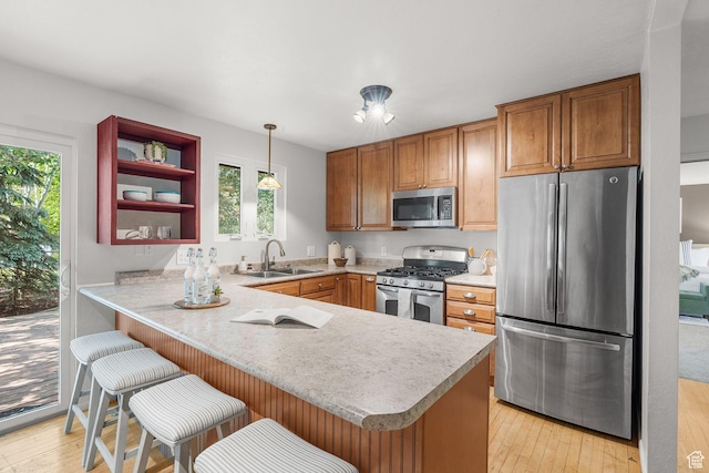 745 Quaking Aspen Ct, Park City, UT 84060 - kitchen with stainless steel appliances, a peninsula, light countertops, and brown cabinets