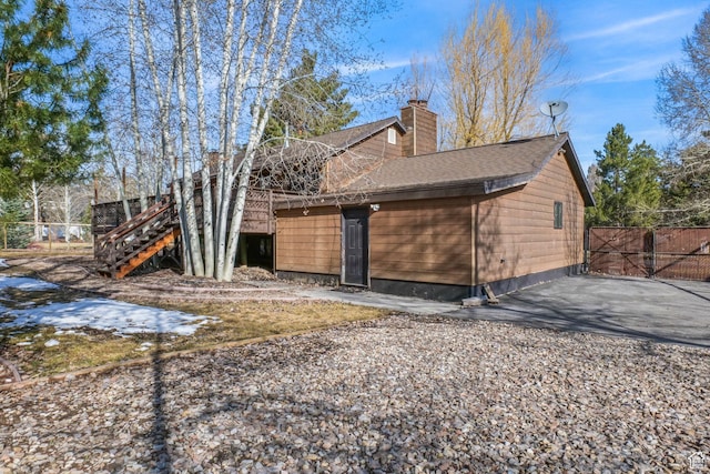 745 Quaking Aspen Ct, Park City, UT 84060 - exterior space with a chimney, a shingled roof, fence, and stairway