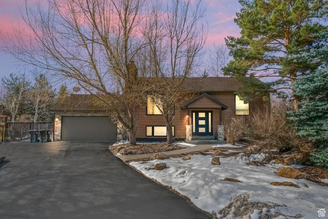 745 Quaking Aspen Ct, Park City, UT 84060 - split foyer home with aphalt driveway, a garage, and fence