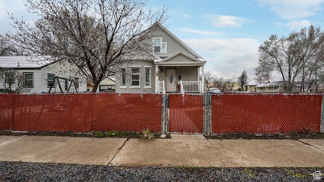 501 E Cross St, Ogden, UT 84404 - view of front facade featuring a fenced front yard, covered porch, and a gate