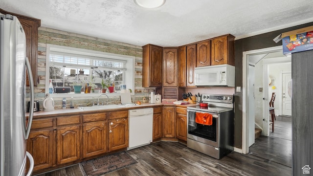 501 E Cross St, Ogden, UT 84404 - kitchen featuring dark wood finished floors, a textured ceiling, a sink, and appliances with stainless steel finishes