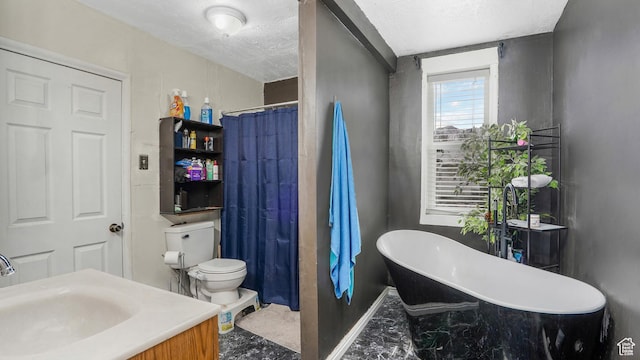 501 E Cross St, Ogden, UT 84404 - full bathroom featuring a freestanding tub, a textured ceiling, a sink, and toilet