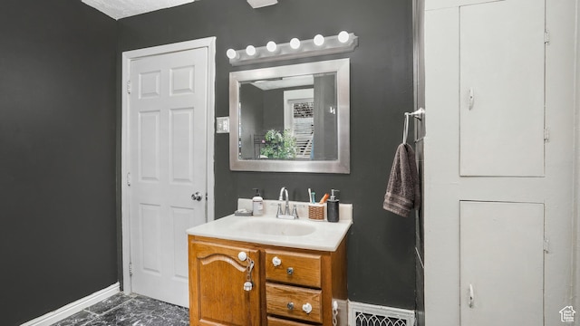 501 E Cross St, Ogden, UT 84404 - bathroom featuring marble finish floor, vanity, and baseboards