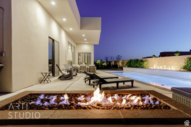 view of patio / terrace featuring fence and an outdoor fire pit