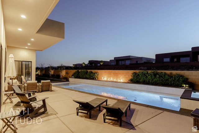 view of swimming pool featuring a patio and fence