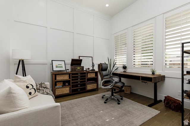 office featuring a decorative wall, wood finished floors, and recessed lighting