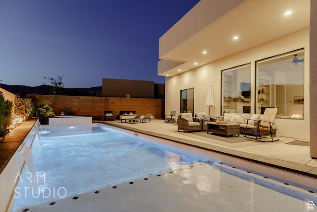 view of pool with fence, a patio, and an outdoor hangout area