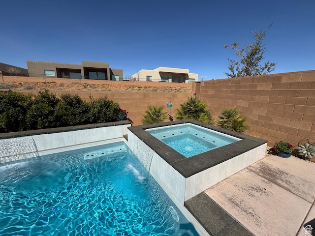 view of pool with an in ground hot tub and a fenced backyard