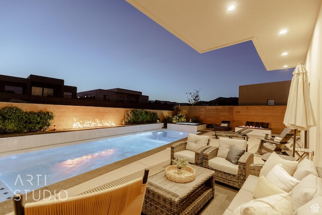 view of swimming pool with an in ground hot tub, outdoor lounge area, and a fenced backyard