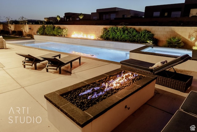 view of swimming pool featuring a jacuzzi, a patio area, and a fenced backyard