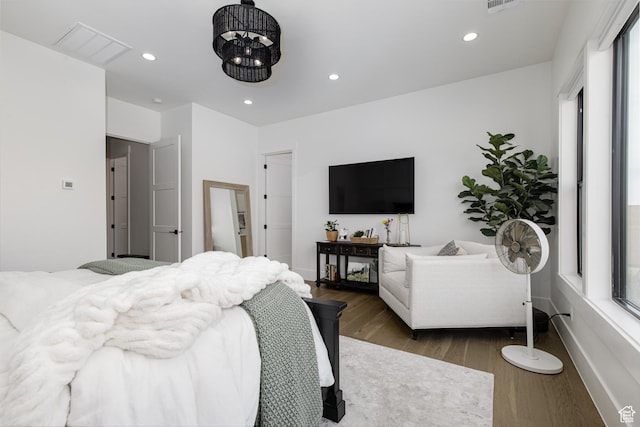 bedroom featuring visible vents, recessed lighting, multiple windows, and wood finished floors