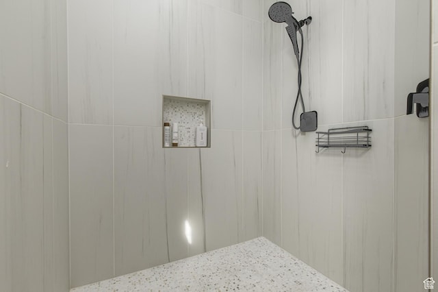 bathroom with tiled shower