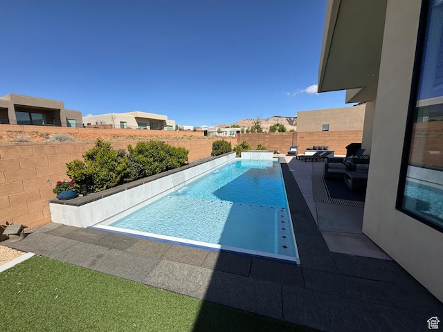view of pool with a fenced in pool, a patio area, and a fenced backyard