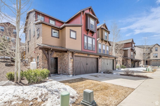 865 W Benjamin Pl, Kamas, UT 84036 - view of front of house featuring driveway, a garage, and stone siding