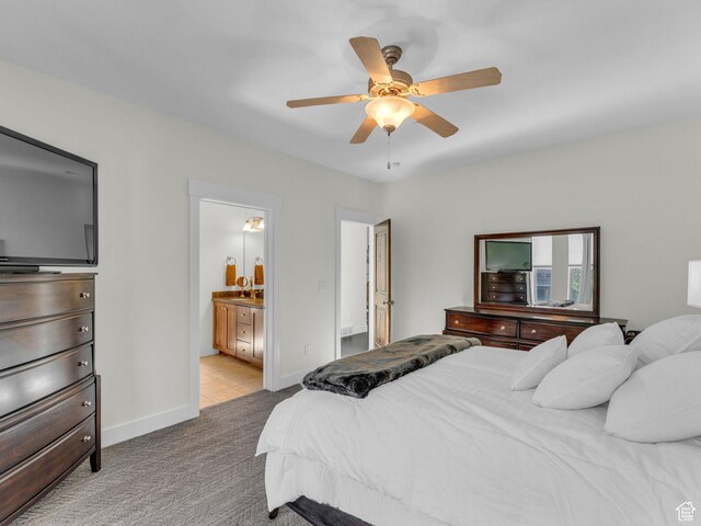 865 W Benjamin Pl, Kamas, UT 84036 - carpeted bedroom with ensuite bath, a sink, baseboards, and a ceiling fan