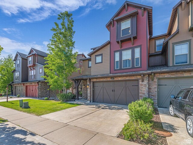865 W Benjamin Pl, Kamas, UT 84036 - multi unit property featuring an attached garage, stone siding, and concrete driveway