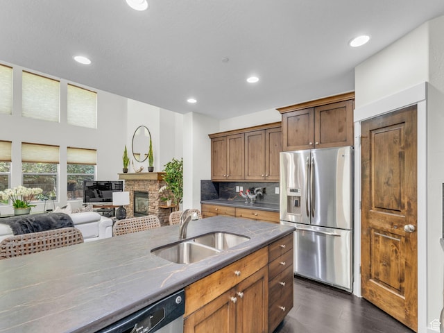 865 W Benjamin Pl, Kamas, UT 84036 - kitchen featuring appliances with stainless steel finishes, a sink, a fireplace, dark wood-type flooring, and recessed lighting