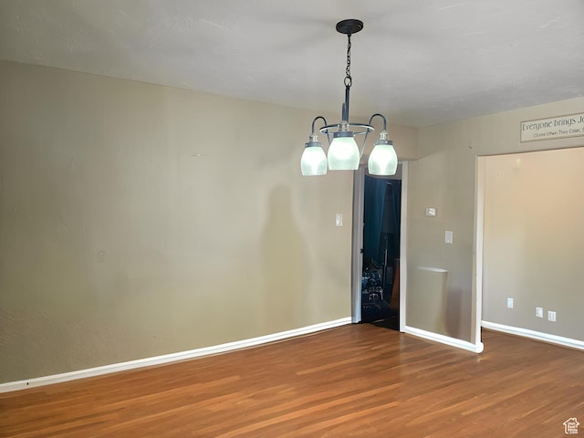 1989 W 1800 N, St George, UT 84770 - spare room with wood finished floors, baseboards, and a notable chandelier