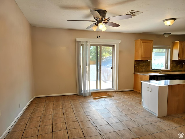 1989 W 1800 N, St George, UT 84770 - kitchen featuring baseboards, light tile patterned floors, backsplash, visible vents, and ceiling fan