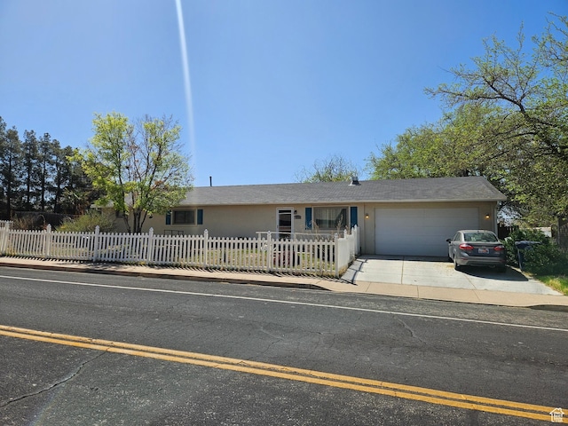 1989 W 1800 N, St George, UT 84770 - view of front of property with a garage, concrete driveway, and a fenced front yard