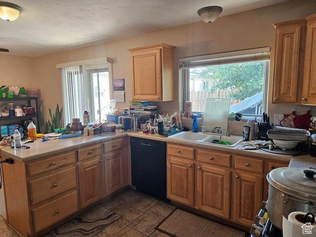 1989 W 1800 N, St George, UT 84770 - kitchen with black dishwasher, a peninsula, light countertops, and healthy amount of natural light